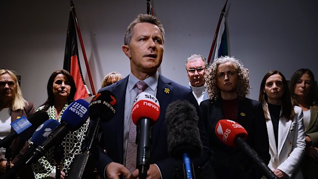 Jason Clare with state education ministers during a press conference on Friday.