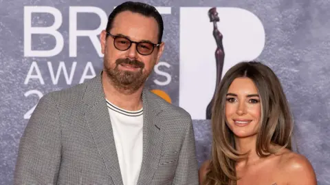 Getty Images Danny and Dani Dyer posing on the Brit Awards 2025 red carpet