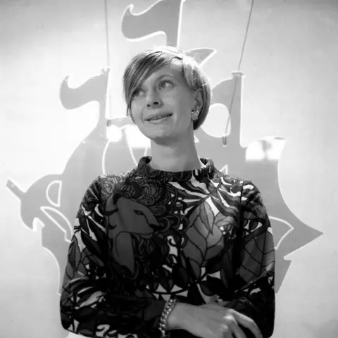 Getty Images Biddy Baxter in front of the BBC logo