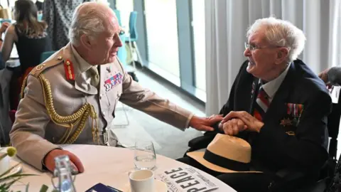 Eddie Mulholland/Daily Telegraph/PA Wire King Charles III with Charlie Richards, 104, during a reception for VJ Day veterans and their families following a national Service of Remembrance to mark the 80th Anniversary of VJ Day at the National Memorial Arboretum 