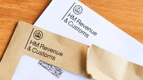Getty Images Two envelopes, one brown and one white, which have been sent by HMRC. They read "HM Revenue and Customs" on the front with a crown logo.