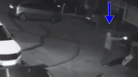 Police handout Black and white footage captures Betro standing and firing at the house in the cul de sac 