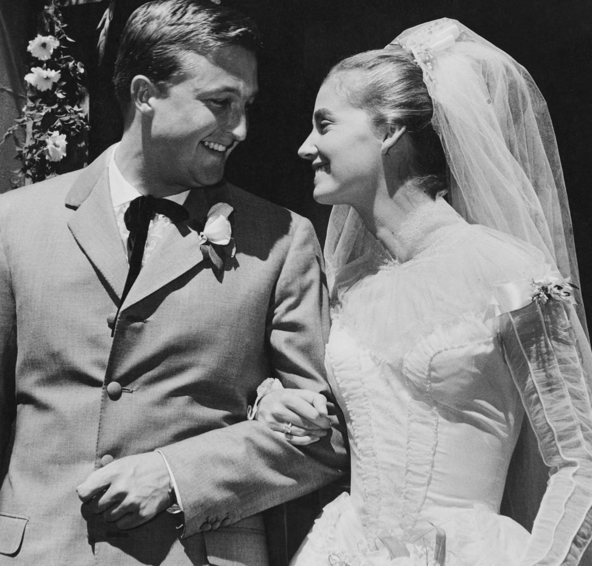 A wedding couple look at each other in this black and white photo.