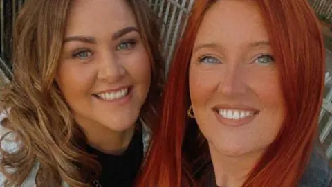 Jemma Louise Gough Jemma Louise Gough and Jamie Lee Watkins smile and pose for a selfie together. Jemma has red long hair and blue eyes. Jamie has dark blonde hair and blue eyes. 