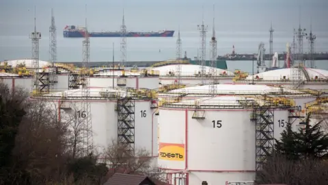 Bloomberg Oil storage tanks as a tanker sails beyond in Tuapse, Russia