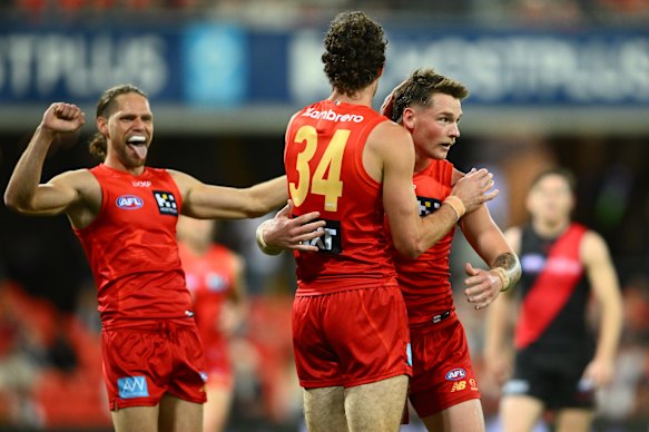 Ben King of the Suns celebrates kicking a goal.
