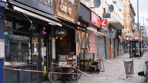 PA Media Exterior of restaurant after shooting with police tape cordoning the scene