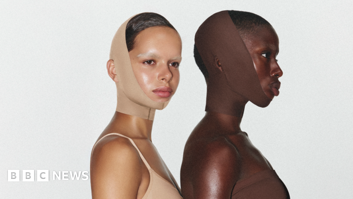 Two women wearing a face wrap that goes under their chins to the top of their heads