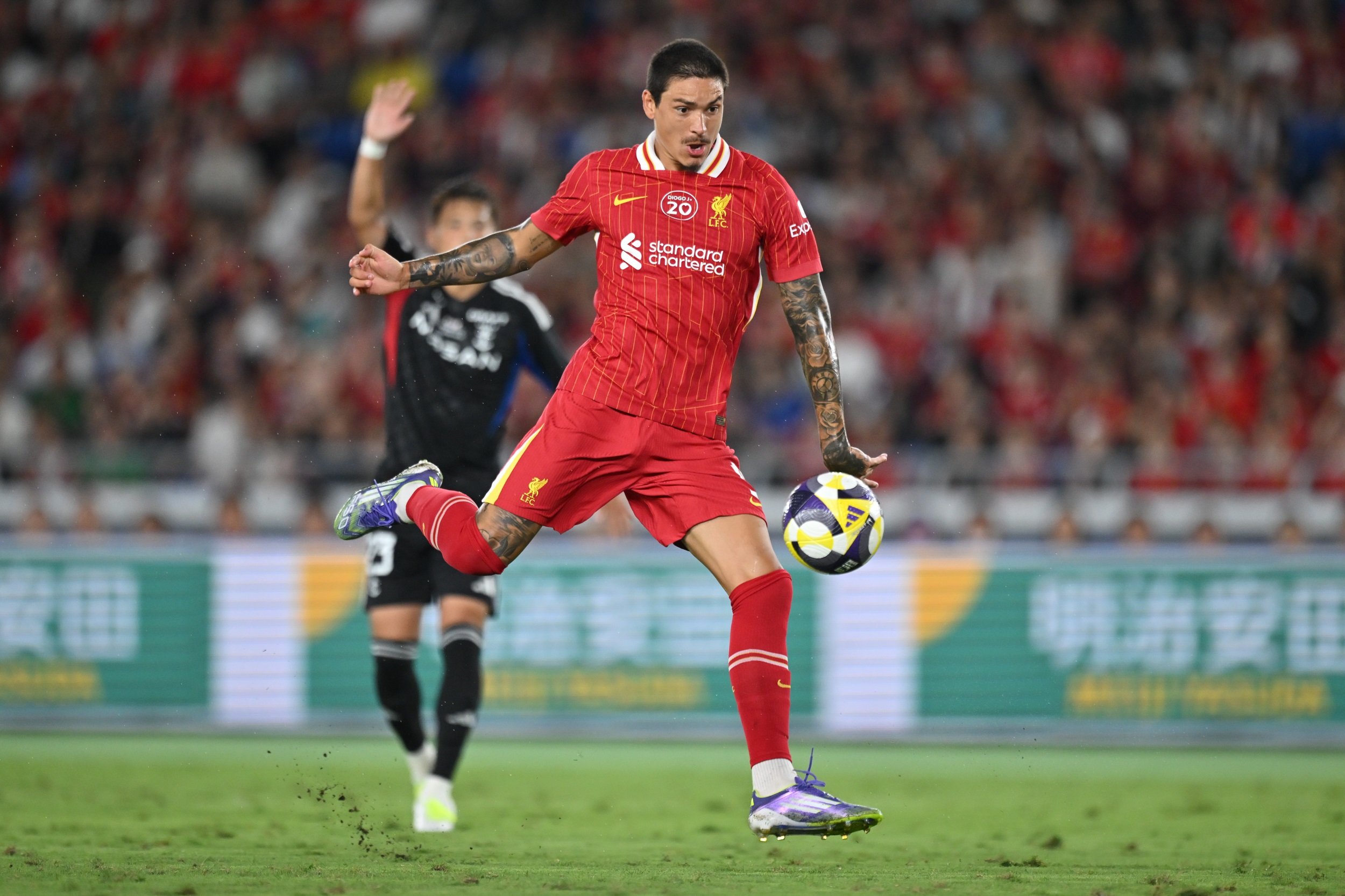 Darwin Nunez pulls his leg back to take a shot.