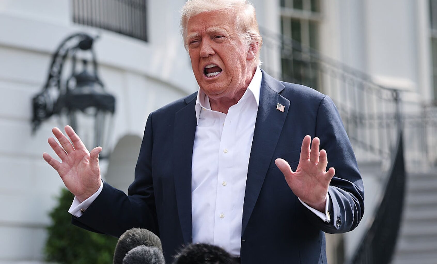 President Donald Trump answers questions while departing the White House on July 11, 2025. (Win McNamee/Getty Images)