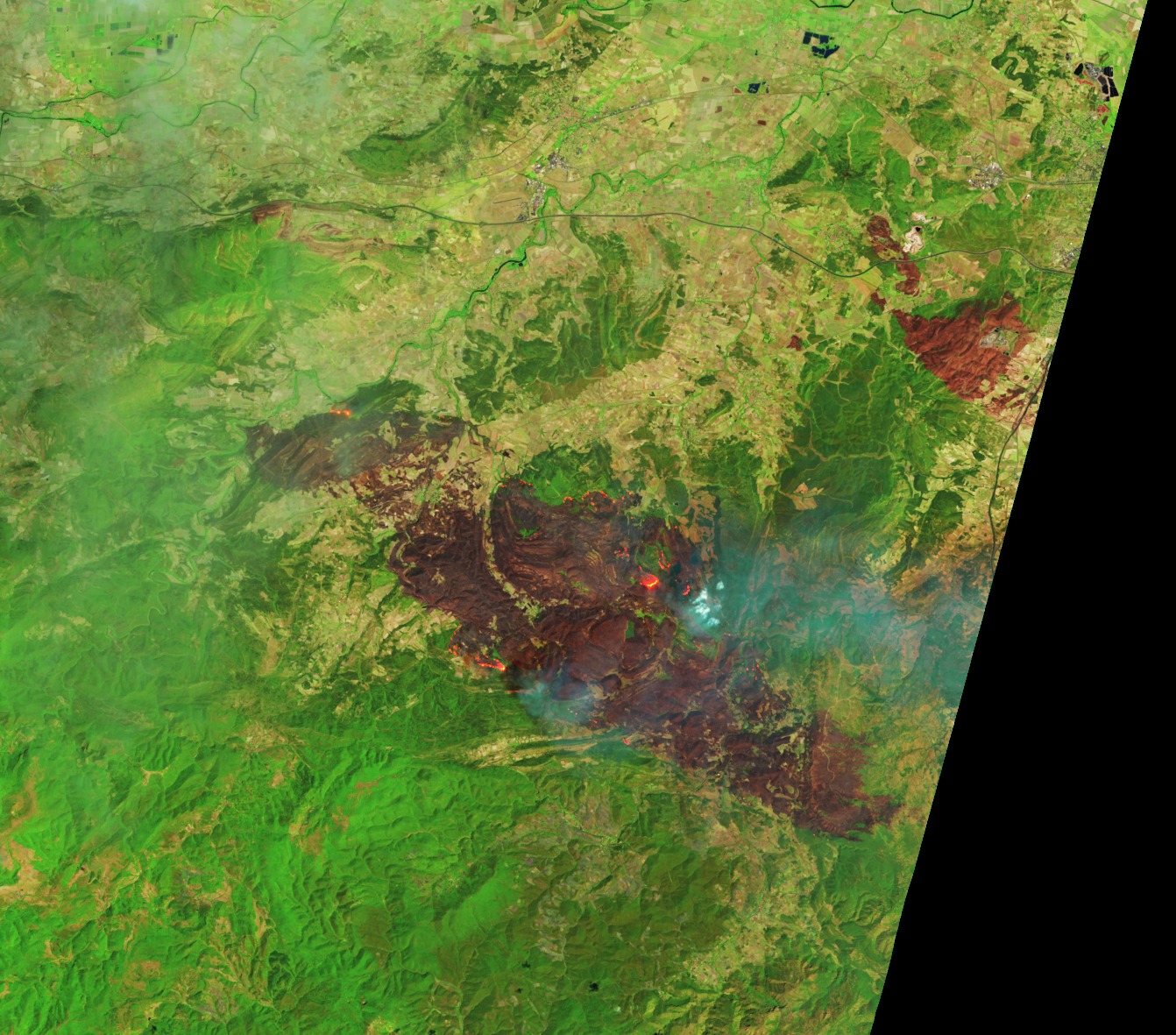 a swath of red stretches through an otherwise green landscape