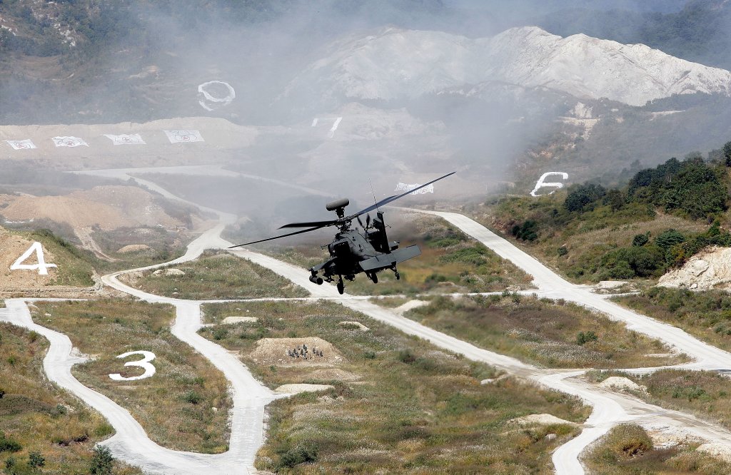 POCHEON, SOUTH KOREA - SEPTEMBER 30: An AH64 Apachi helicopter hovers during the South Korea and U.S. joint military exercise to commemorate the 63th Korea Armed Forces Day at the Seungjin firing drill ground on September 30, 2011 in Pocheon, South Korea. The exercise is intended to prepare the South Korean defence force for any potential action from North Korea. (Photo by Chung Sung-Jun/Getty Images)