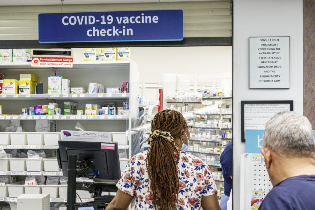 Miami Beach, Florida, Walgreens, Pharmacy and counter Covid-19 vaccine check-in sign