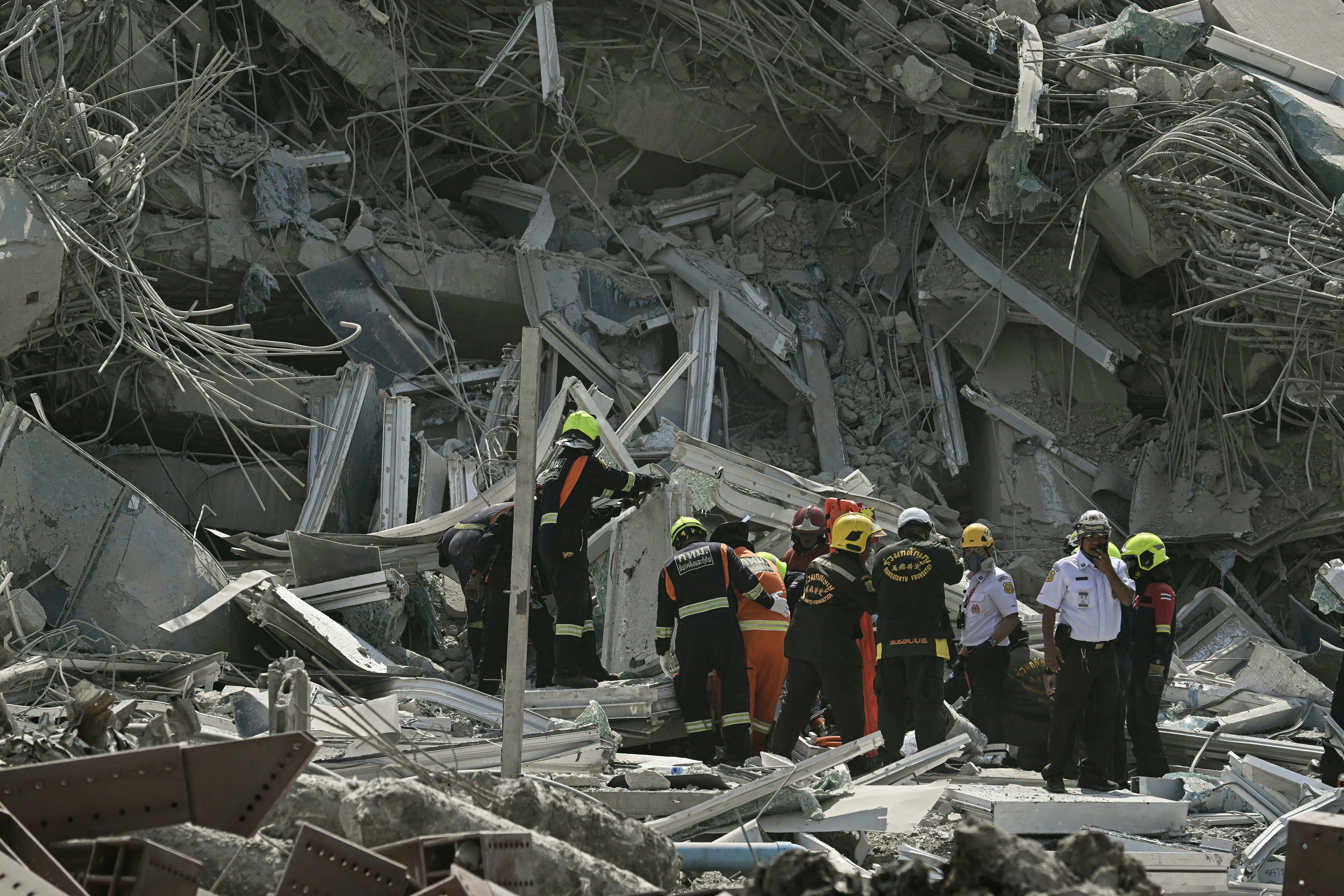 Rescue teams pictured in front of a collapsed building following the earthquake in Bangkok earlier this year