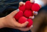 A House page holds foam clown noses tossed from the balcony after the House delays for a third time, in order to get a quorum during the first day of the special legislative session at the Oregon State Capitol, Aug. 29, 2025.