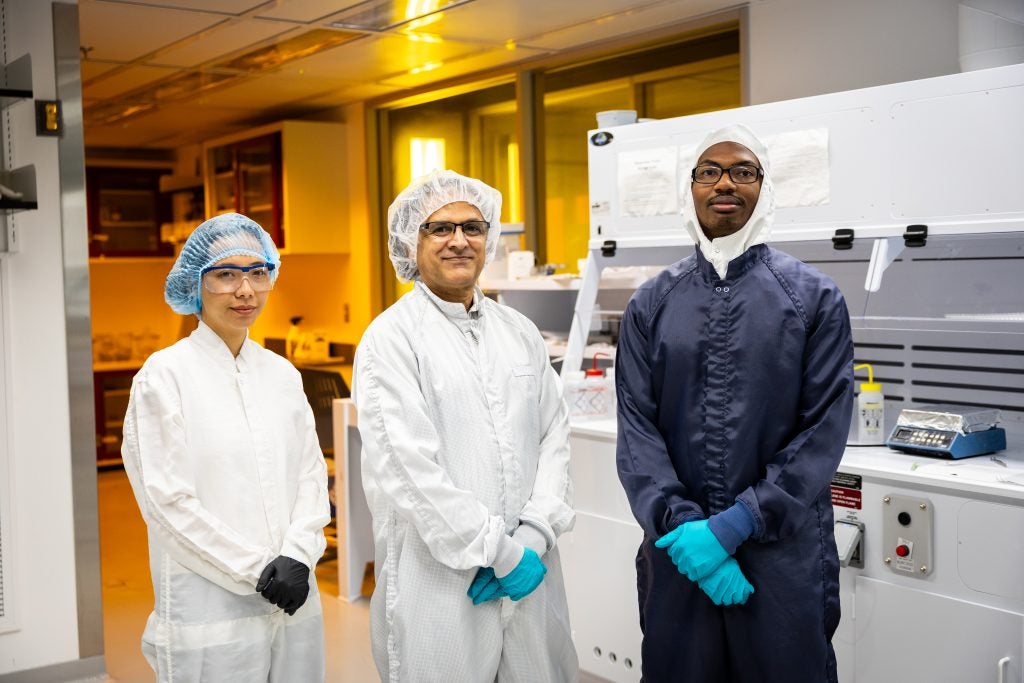 Paranjape with two students in the lab