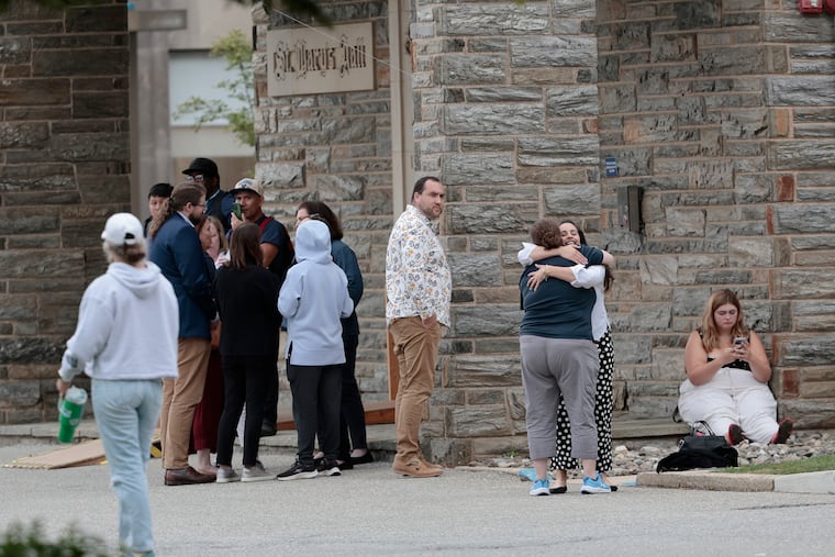People who had been sheltering in place inside Villanova University’s St. Mary’s Hall gather outside after the all clear had been given by police. An earlier active shooter reported proved to have been a hoax.