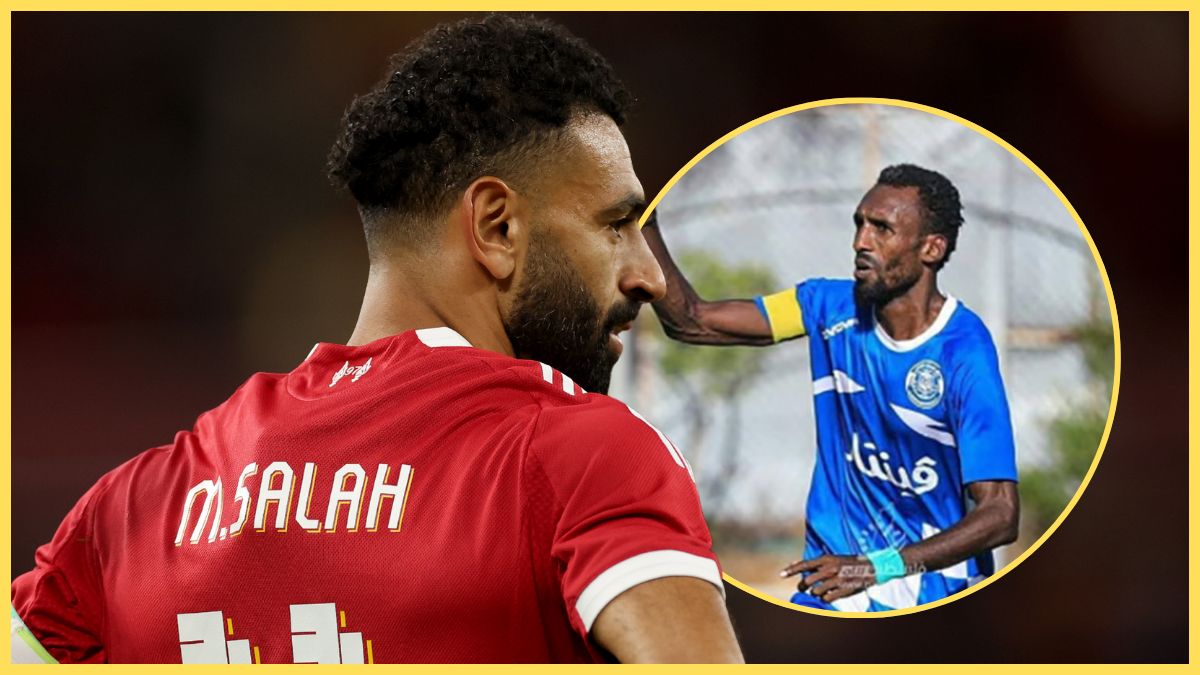 Mo Salah looks on with hands on hips next to Suleiman Al Obeid.