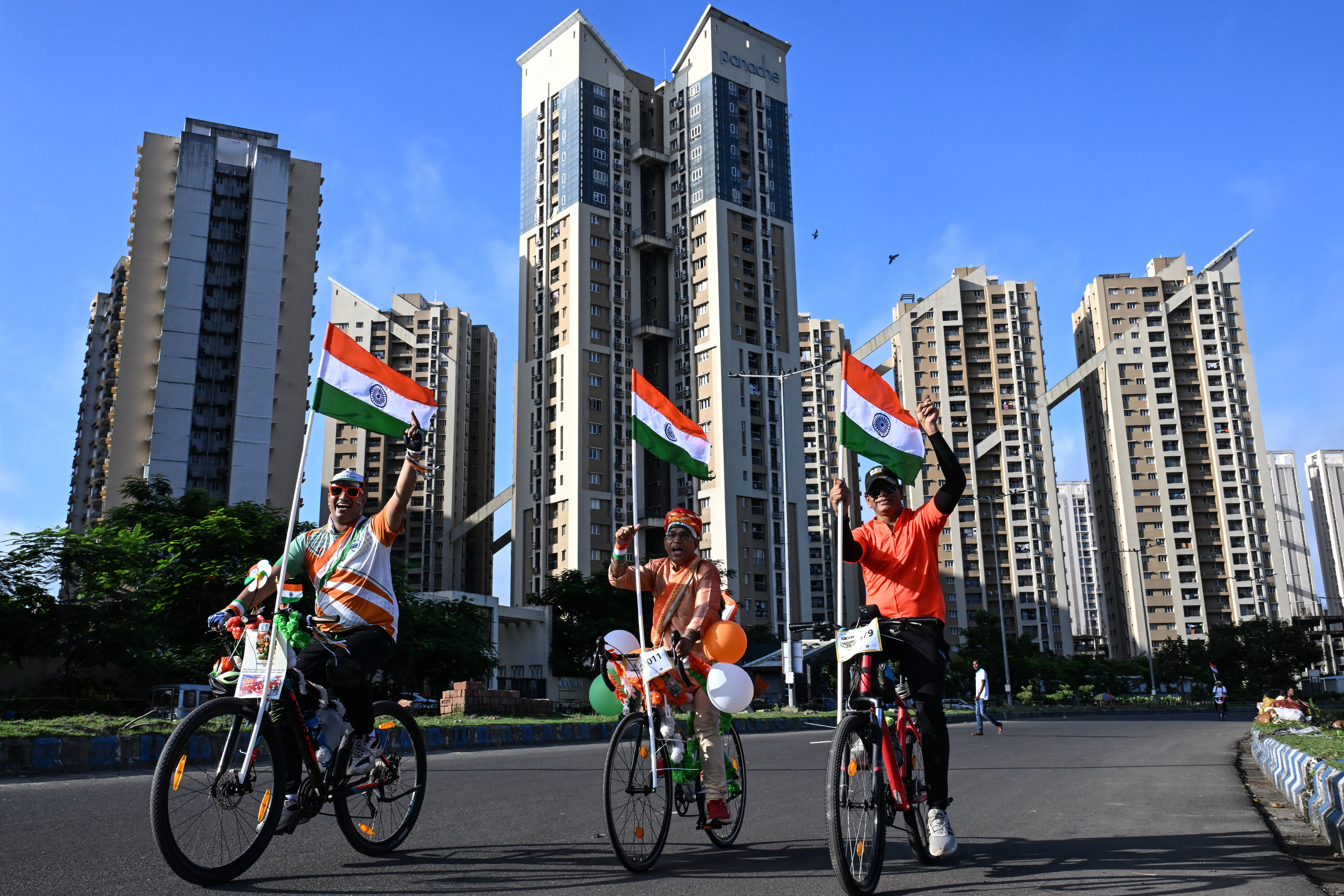 Cyclists carrying Indian national flags participate in a rally during the country's Independence Day celebrations in Kolkata