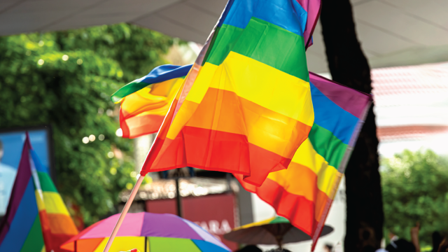 Parade-goers wave a rainbow flag at a Pride Month march in Bangkok, Thailand. (Getty Images)