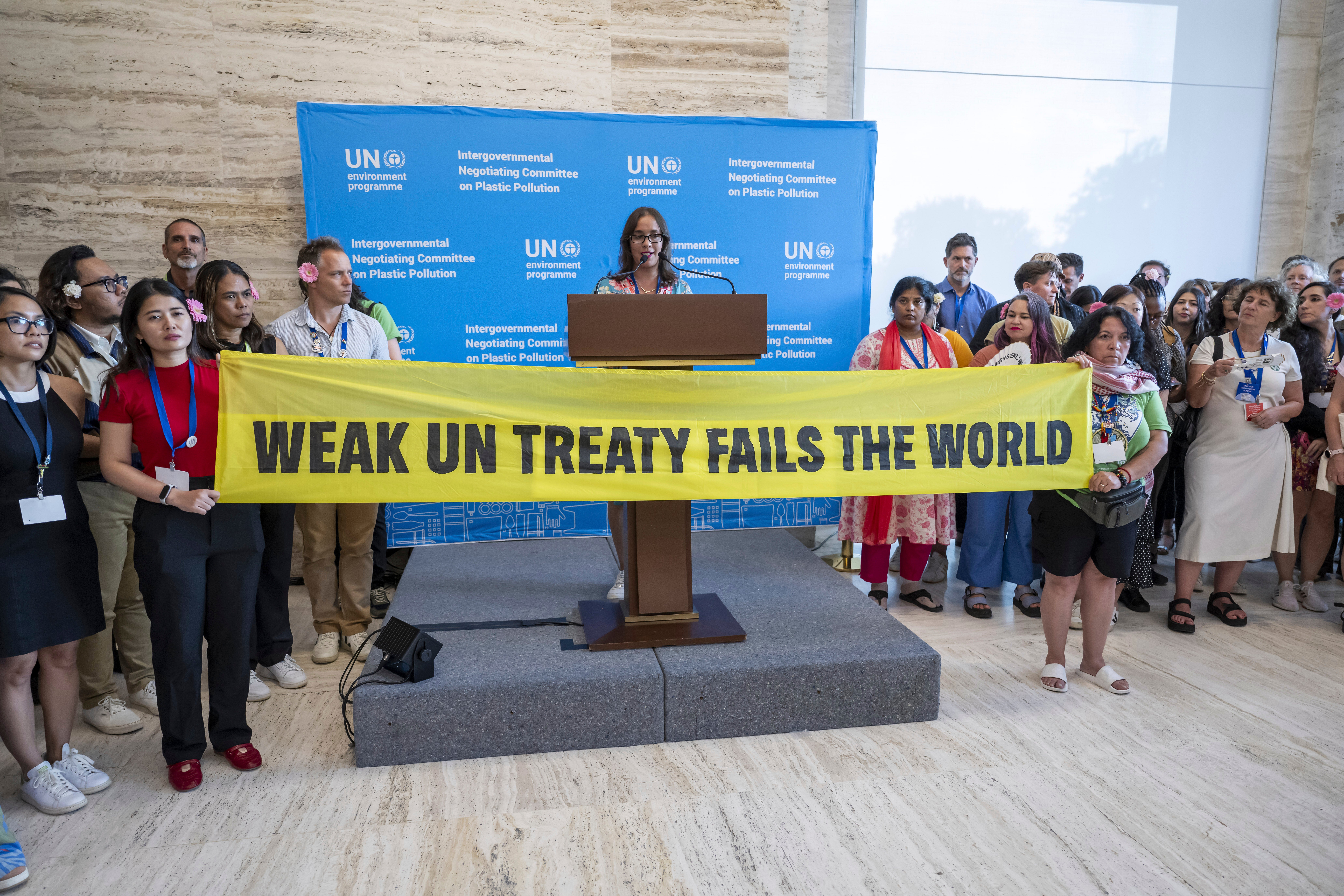 Activists stage a protest during the Plastic Pollution negotiations at the United Nations headquarters in Geneva, Switzerland on Thursday 14 August