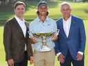 Tommy Fleetwood of England poses with the Fedex Cup trophy and Brian Rolapp, CEO of the PGA Tour, and Jay Monahan, Commissioner of the PGA Tour, after the final round of the TOUR Championship 2025 at East Lake Golf Club on Aug. 24, 2025 in Atlanta, Ga. 