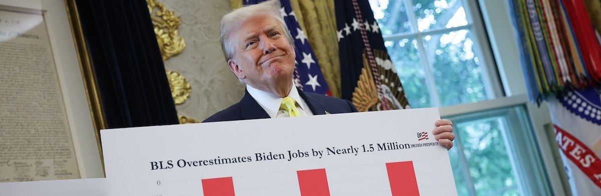 WASHINGTON, DC - AUGUST 07: U.S. President Donald Trump holds a chart which reads "Bureau of Labor Statistics (BLS) Overestimates Biden Jobs by Nearly 1.5 Million" in the Oval Office on August 07, 2025 in Washington, DC. Trump fired Bureau of Labor Statis