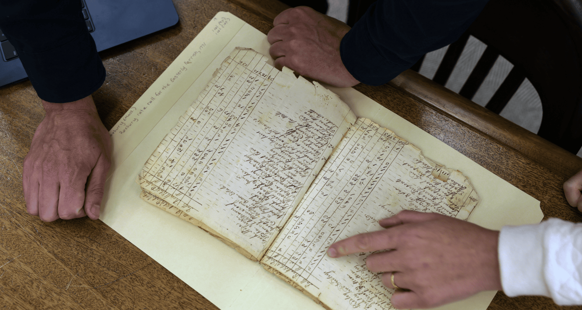 Gabriel Raeburn and Christine Bachman-Sanders reviews documents.