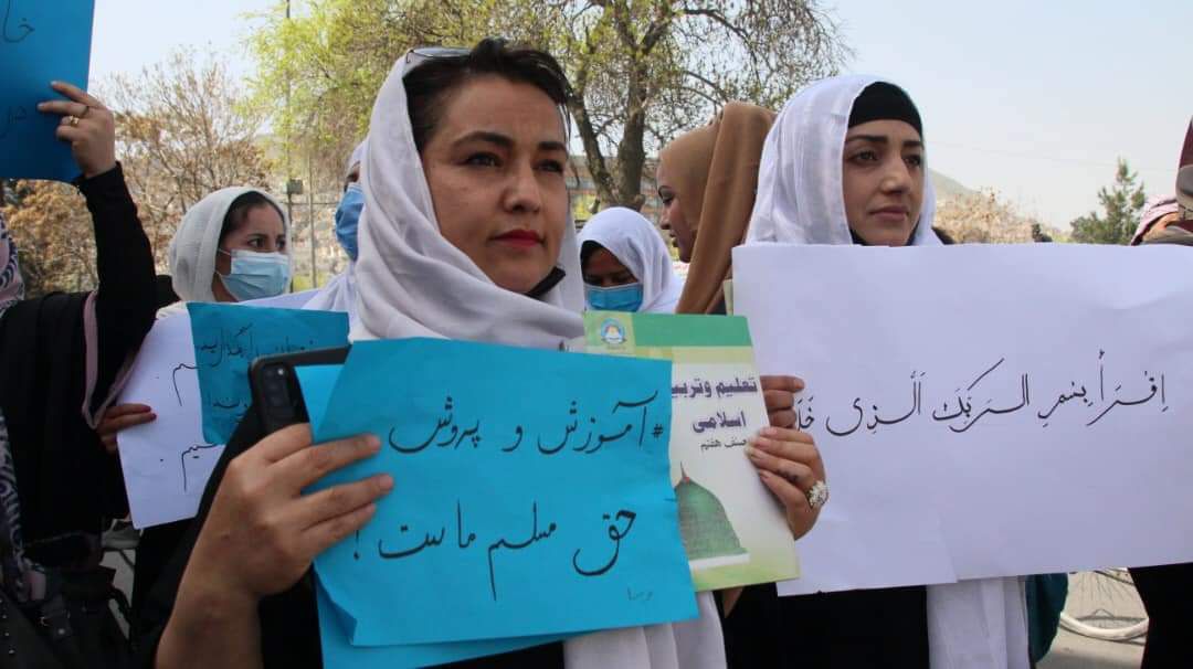 Afghan woman Julia Parsi (L) who protested against the Taliban in 2022 and was arrested