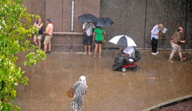 Pedestrians seek shelter from the rain Filbert Street near the Marriott hotel as storms hit the area Thursday afternoon July 31, 2025.