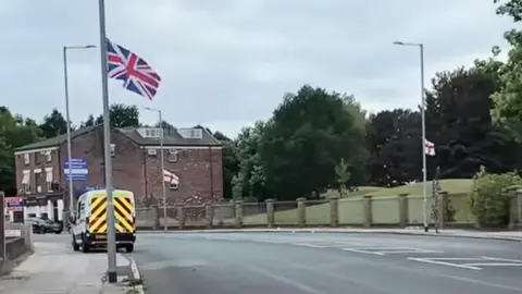 Adikia Media A union flag and two St George's flag on lamp-posts in Liverpool