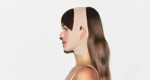 Skims Woman wearing a Skims face wrap