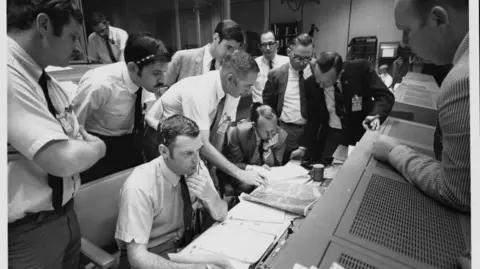 Getty Images Flight controllers at Nasa working out how to get the crippled Apollo 13 back to Earth.