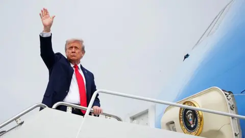 Getty Images US President Donald Trump waving as he boards Air Force One to depart Joint Base Elmendorf-Richardson 
