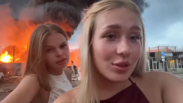 Two women posted themselves rapping as the fire burned behind them