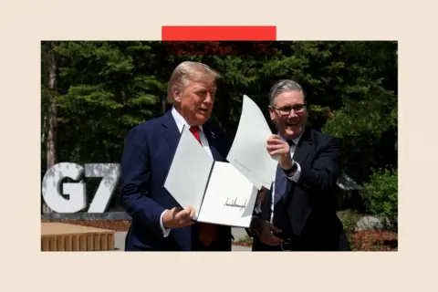 REUTERS/Suzanne Plunkett/Pool U.S. President Donald Trump and British Prime Minister Keir Starmer hold a signed Trade Agreement during a meeting at the G7 summit