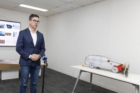 Brad Battin at the 2023 press conference in which a cardboard cutout and figurines were used to recreate the car crash.