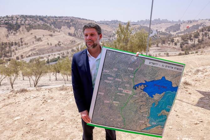 Israeli Finance Minister Bezalel Smotrich holds map of an area near the settlement of Maale Adumim,a land corridor known as E1.