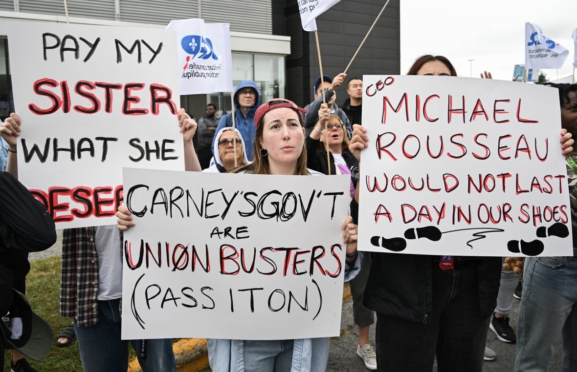 People hold up signs during a demonstration.