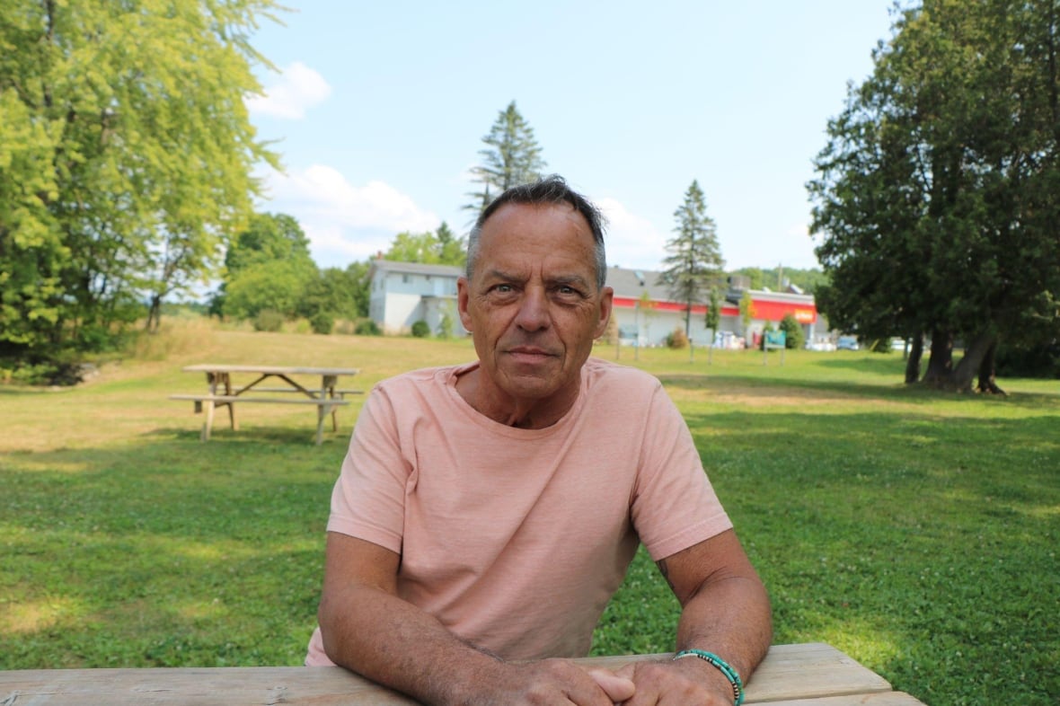A man sitting on a picnic bench. 