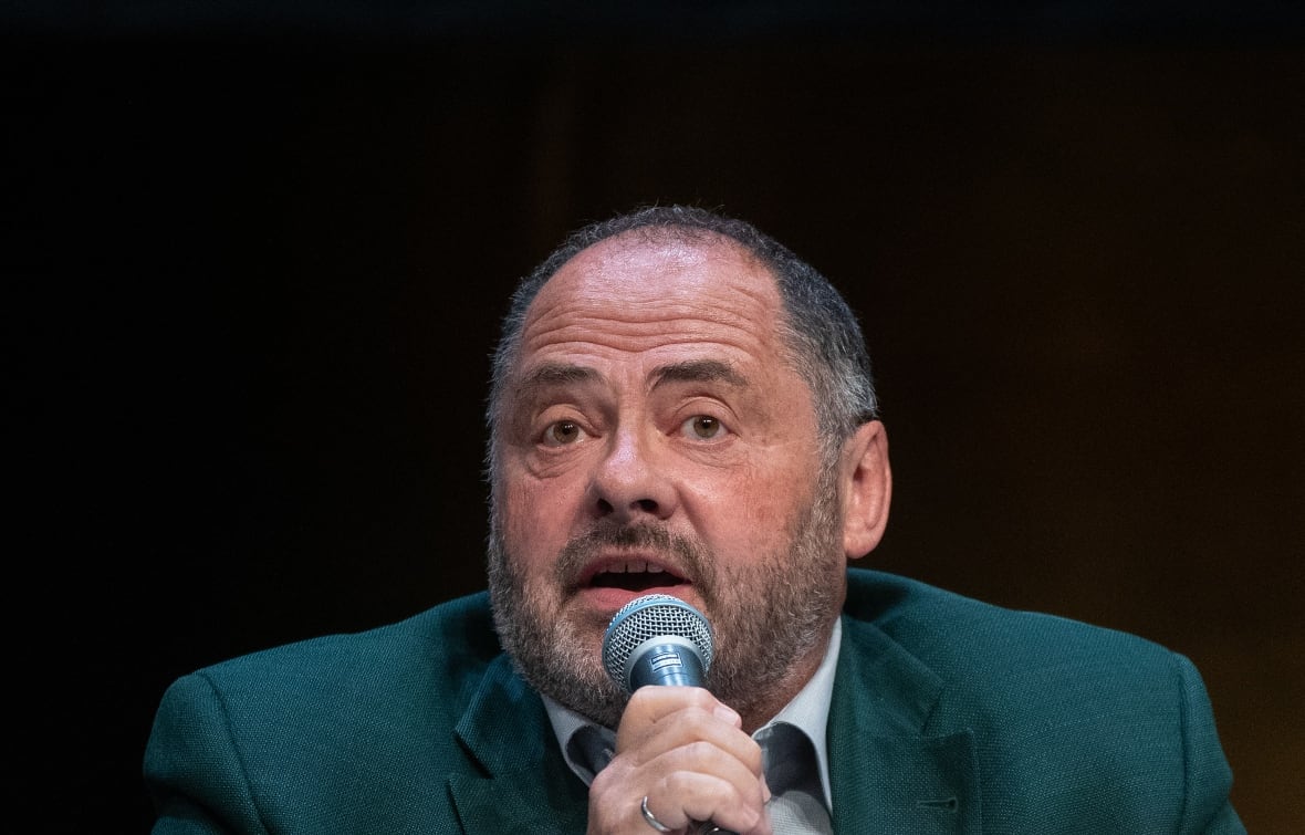 A man speaks into a microphone.