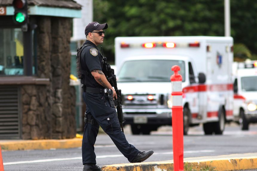 A security guard stands outside the main gate at Joint Base Pearl Harbor-Hickam, in Hawaii on December 4, 2019.