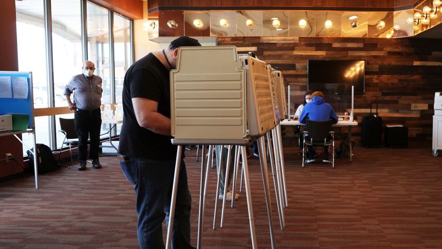 A man fills out his ballot after registering to vote at Vanguard Church in Colorado Springs, Colorado, on November 3, 2020. The church served as a location where voters could register, drop off completed ballots or fill out a ballot in person. (Forrest Czarnecki/The Gazette via AP)