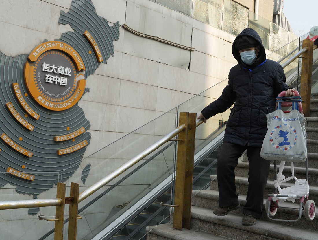 Residents walk through a partially shuttered Evergrande commercial complex in Beijing, Monday, Jan. 29, 2024.