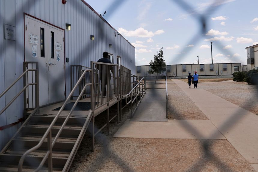 Immigrants walk through the ICE South Texas Family Residential Center , in Dilley, Texas on August 23, 2019.