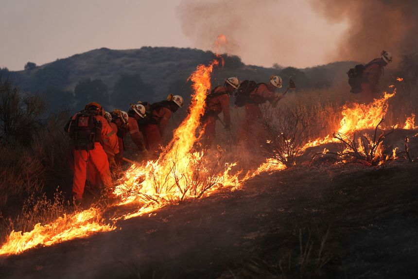 A California Department of Corrections fire crew battles the Canyon Fire on Thursday, in Halsey Canyon, California.