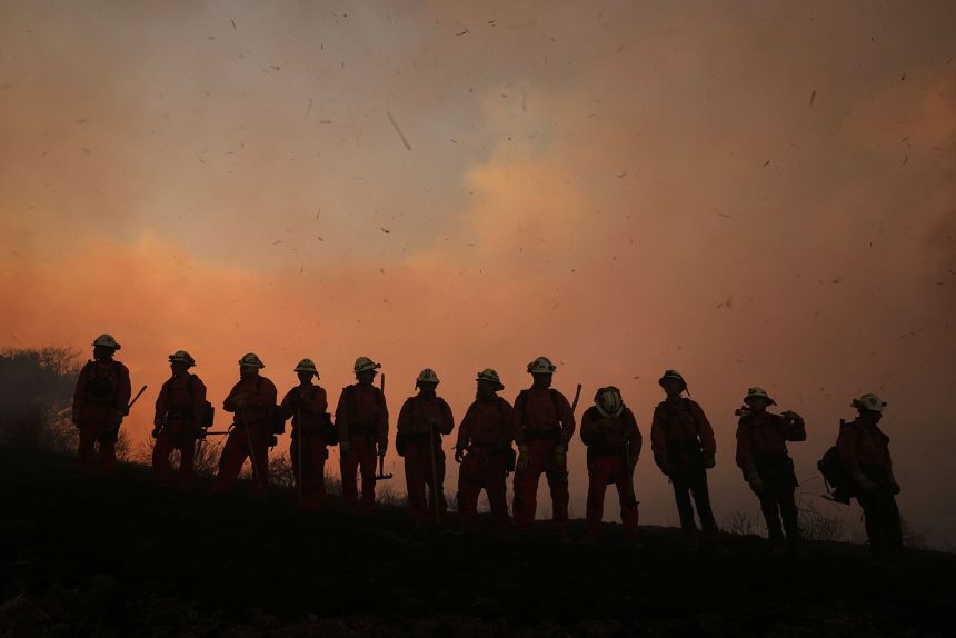 A California Department of Corrections fire crew looks on as the Canyon Fire burns on Thursday in Halsey Canyon, California.