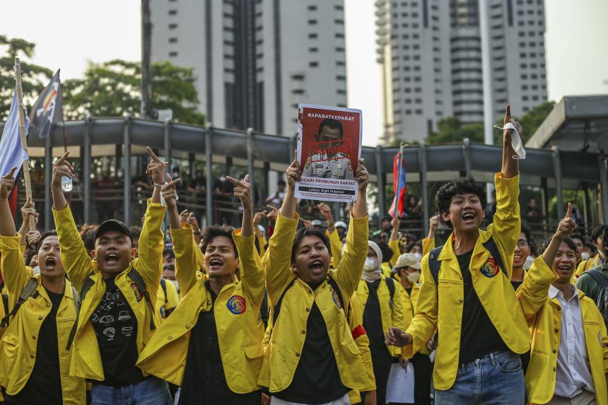A crowd stages a demonstration in front of the Metro Jaya Regional Police Headquarters in Jakarta, Indonesia, today.