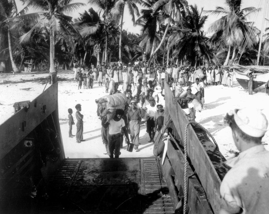 An advance team of Bikini men board a landing craft to assist US Navy Seabees in building new homes for the islanders on Rongerik. The Bikinians had to evacuate their island before 