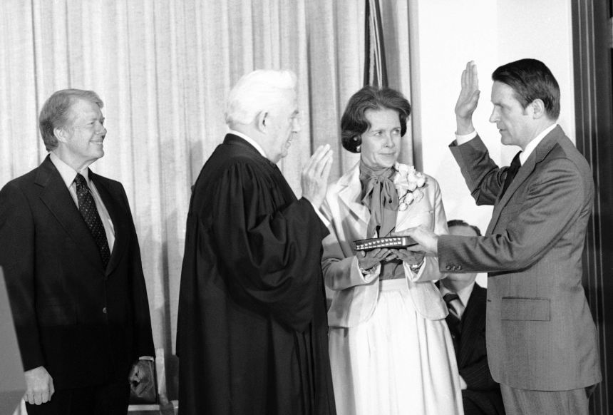 President Jimmy Carter, left, smiles as Chief Justice Warren Burger administers the oath of office to new FBI Director William H. Webster in Washington on February 23, 1978.